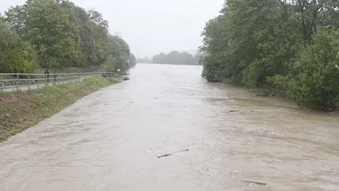 The turbulent flow of a river that overflowed its banks during a flood in Austri Stock Footage 284737551