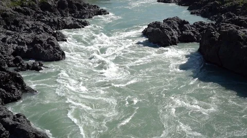 Turbulent mountains river stream through volcanic rocks Stock Footage 113139731