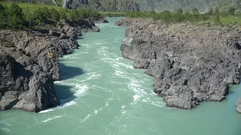 Turbulent mountains river stream through volcanic rocks Stock Footage 113139737