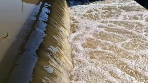 Turbulent Water Flow and Bubbles Over Concrete Dam Sluice Gate Stock Footage 332885776