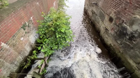 Turbulent Water Rushing Through an Old Brick and Stone Channel Stock Footage 340080155