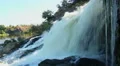 Turbulent waterfall splashing against the rocks, power of nature HD Footage