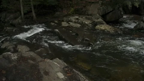 Turbulent waters pick up speed over boulders 스톡 동영상 166534961