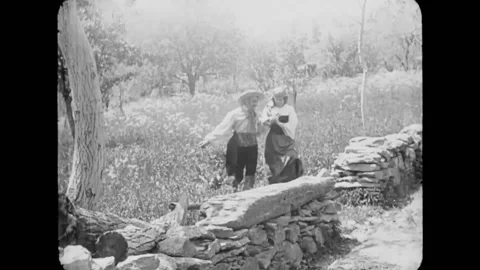 TURIN - 1911 - A rustic couple exchanges flowers and affectionate gestures by a Stock Footage 341994152
