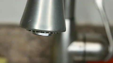 Turing on a kitchen faucet during the day Video stock 63058326