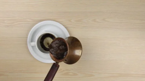 Turk pouring freshly brewed coffee to a classic cup Stock Footage