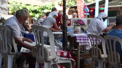 TURKEY 18th JULY 2016. Old man reading his newspaper in Turkish street market Stock Footage 65155114