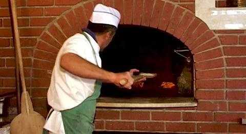 Turkey, 2009. The cook places flatbreads on wooden lotata and puts them in oven Stock Footage 158735367