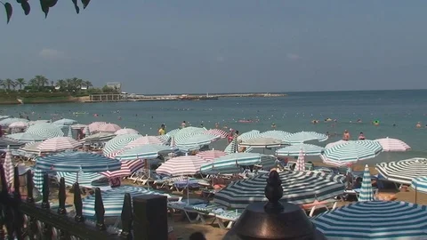 Turkey, Antalya, August 20, 2015 : beach, sun umbrellas,people swim and sunbathe Vídeos de archivo 74914219