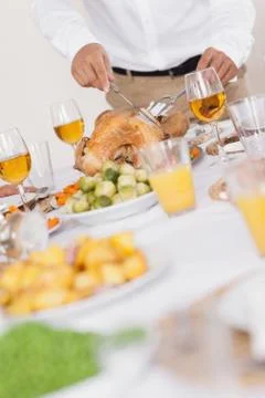 Turkey being carved at dinner table Stock Photos