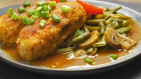 Turkey cutlets with green beans and champignons in tomato sauce garnished Stock Footage 221580786