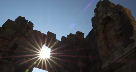 Turkey, Demre - Myra. Rays of the bright sun shine through hole in stone wall of Stock Footage 233602487