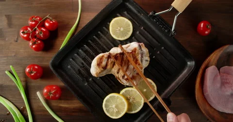 Turkey fillets are fried in pan with pieces of lemon. Stock Footage 140476008