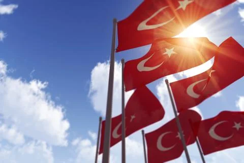 Turkey flags waving in the wind against a blue sky. 3D Rendering Stock Illustration