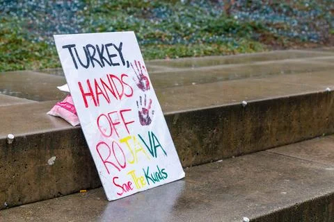 "Turkey Hands Off Rojava Save the Kurds" protest sign with handprints leani.. Stock Photos