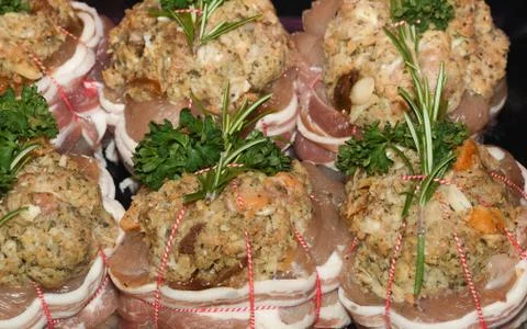 Turkey parcels with mixed game stuffing, wrapped in bacon. Stock Photos