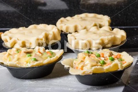 Turkey pot pies being prepared in a kitchen Stock Photos