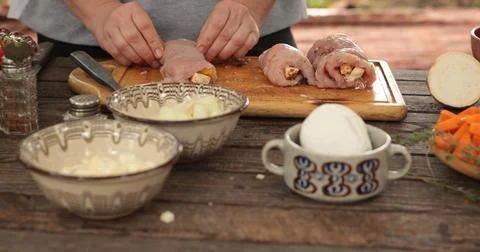 Turkey roll preparation process featuring a chef carefully stuffing turkey cuts Stock Photos