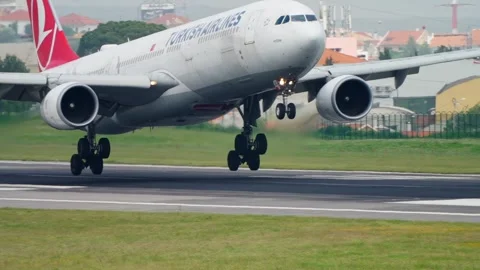 Turkish Airlines A330 touchdown at Lisbon airport with tire smoke Stock Footage 336253359