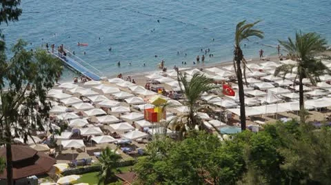 Turkish beach from height, with beach umbrellas, a pier Vídeos de archivo 10035593