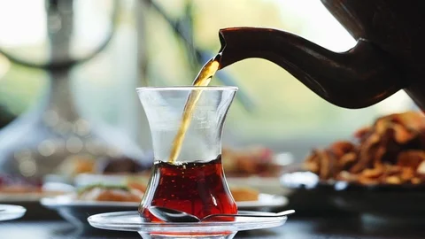 Turkish black tea being poured in a glass Stock Footage 89480946