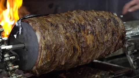 Turkish cag kebab is cooked in front of the fire. Video stock 106020854