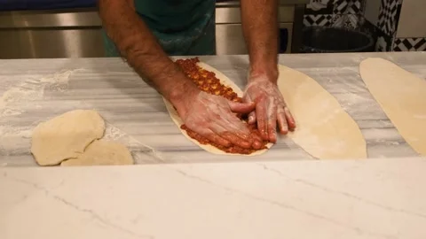 Turkish chef in the hotel puts meat stuffing on the dough Video stock 190922046