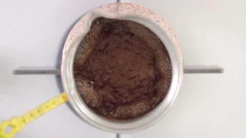 Turkish coffe in copper coffee pot is cooking Stock Footage 131377013