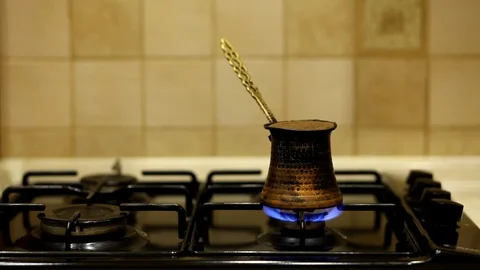 Turkish coffee being prepared over a stove top. Stock Footage 128017880