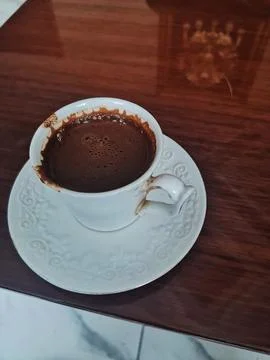 A Turkish coffee cup on a patterned saucer. Stock Photos