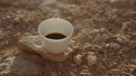 Turkish coffee cup steaming on a desert rock 動画素材 316068966