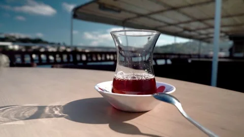 A Turkish cup of tea sits on a table on a ship Stock Footage 281642378