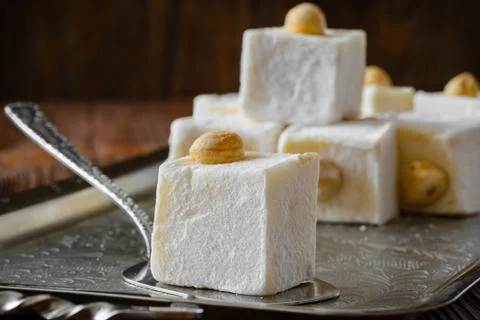 Turkish delight. Eastern dessert with hazelnut on metal plate. Selective focus Stock Photos