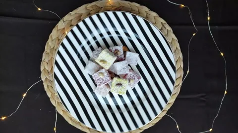 Turkish Delight Rotating On Black and White Striped Plate Stock Footage 147696501