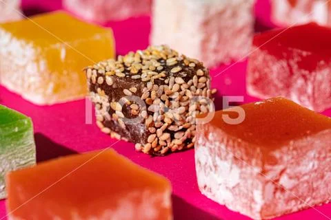 Turkish delight square pieces on a bright pink background Stock Photos