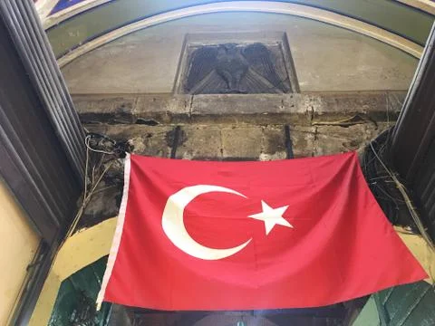 Turkish flag and an eagle relief on it at Grand Bazaar, Istanbul. Stock Photos
