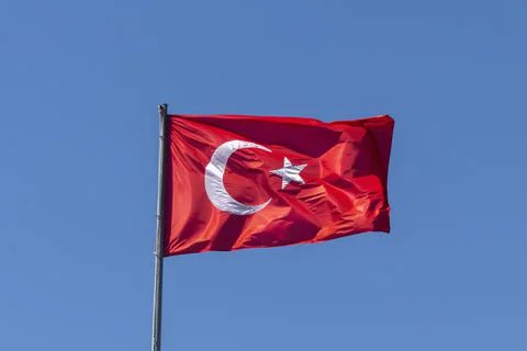 Turkish flag on the background of a clear empty sky Stock Photos