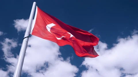 Turkish flag is developing in slow motion. In background is a blue sky Stock Footage 221226458
