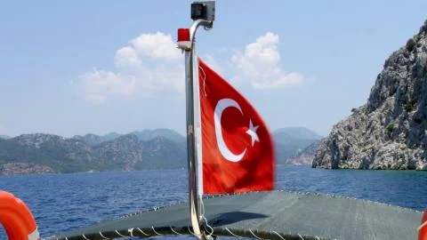 Turkish flag flapping at the back of a boat in the Selimiye. Marmaris. Turkey Stock Photos