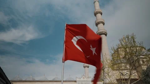 The Turkish flag flies against the background of the mosque Stock Footage 274486556