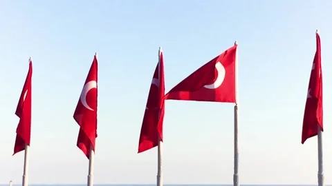 The Turkish flag flutters in the wind against a clear sky, the flag is red wi Stock Footage 135354418