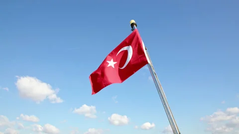Turkish flag flutters in wind against blue sky with white clouds. Flag on stern Stock Footage 222303728