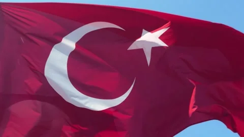 The Turkish flag flutters in the wind, the flag against a blue sky. Stock Footage 330132827