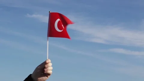 Turkish flag in hand flutters in the wind against the sky, independence nat.. Stock Footage 223827141