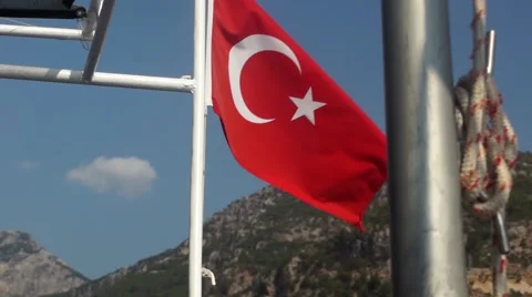 Turkish flag on side of boat with mountain scenery in background Stock Footage 40882638