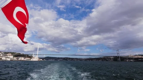A Turkish flag swinging in the wind during a boat tour to the Bosporus Stock Footage 265488583