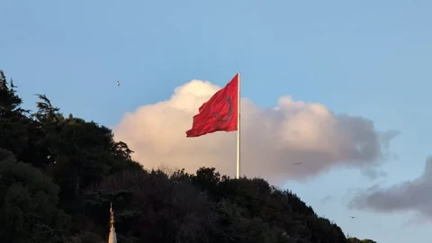 Turkish flag waving in the wind on a hill against a blue sky with clouds Video stock 337808551