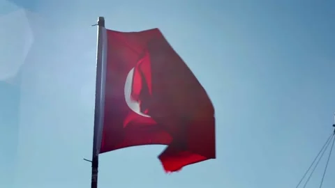 Turkish Flag Waving in Wind with Lens Flare against Blue Sky Stock Footage 332281919