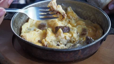 Turkish fried eggs with roasted meat in copper pan Video stock 256951567