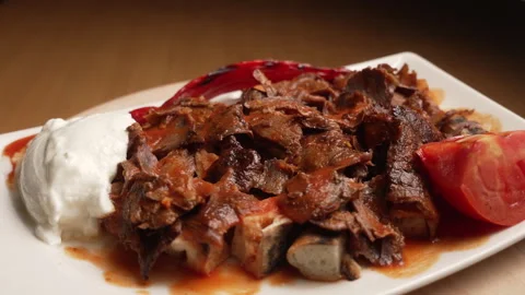 Turkish Iskender Kebab rotating, served with tomato, yogurt, and grilled pepper Stock Footage 333531771